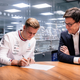 Mick Schumacher (left) signs his new contract alongside Team Principal Toto Wolff (right)